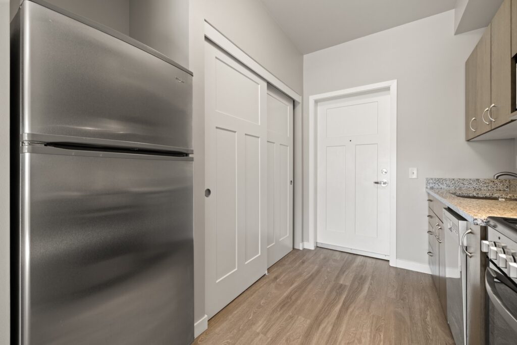 kitchen area with granite countertops, stainless steel appliances and wood-style flooring