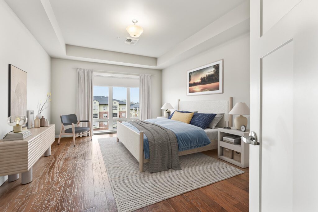 bedroom with wood floors and large windows