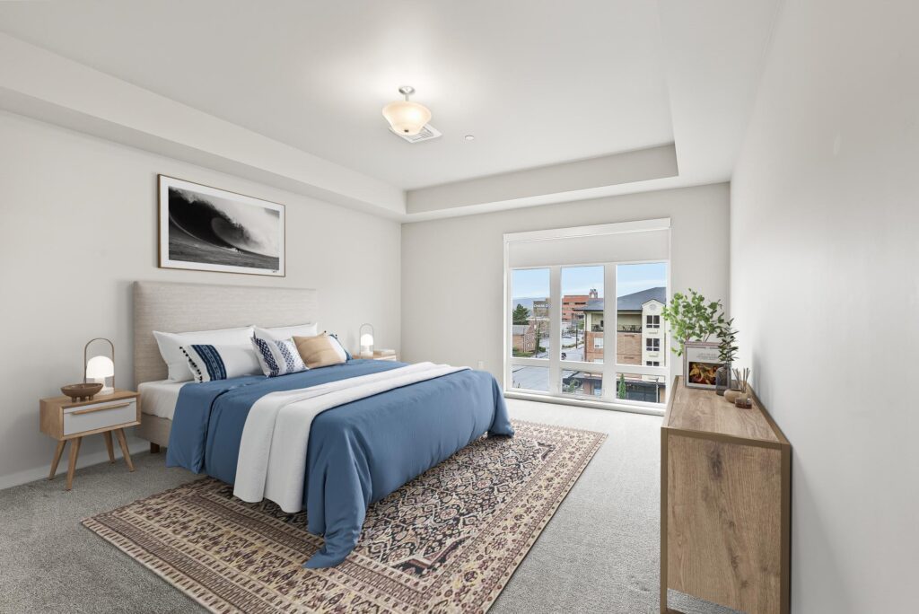 carpeted bedroom with large windows