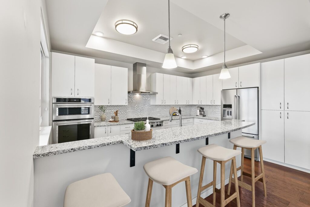 kitchen with stainless steel appliances, granite counters, and tile backsplash